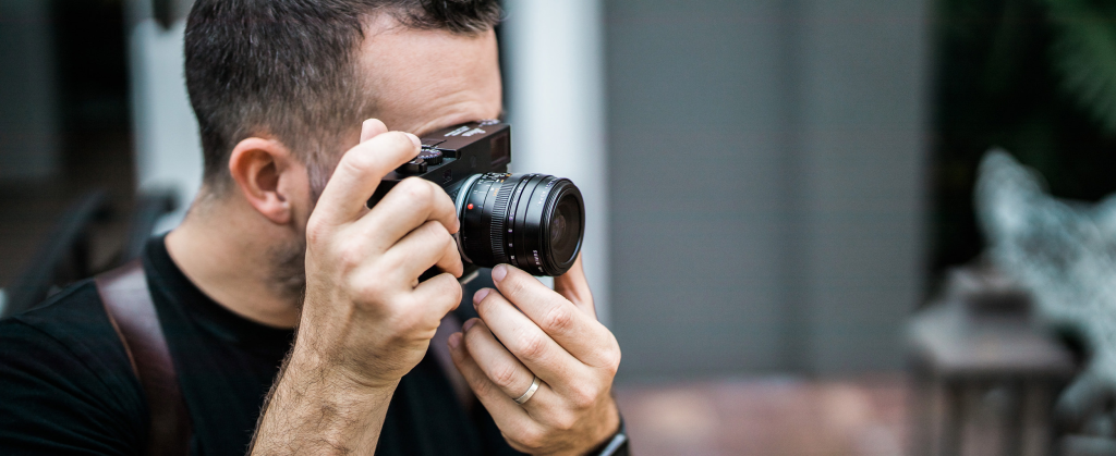 Bud Johnson with Leica camera - editorial portrait